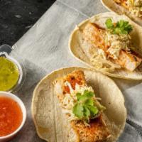 Mahi Tacos (3) · lime cabbage slaw and chili aioli