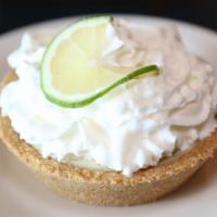 Key Lime Pie · Homemade key lime pie. Graham cracker crust, creamy filling made with Nellie and Joe’s key w...