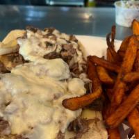Philly Cheese-Steak · Shaved ribeye steak with grilled onions, sautéed mushrooms, and melted provolone cheese serv...