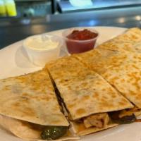 Chicken Quesadilla · A large flour tortilla filled with chicken, onions, peppers, and cheese.  Served with sour c...