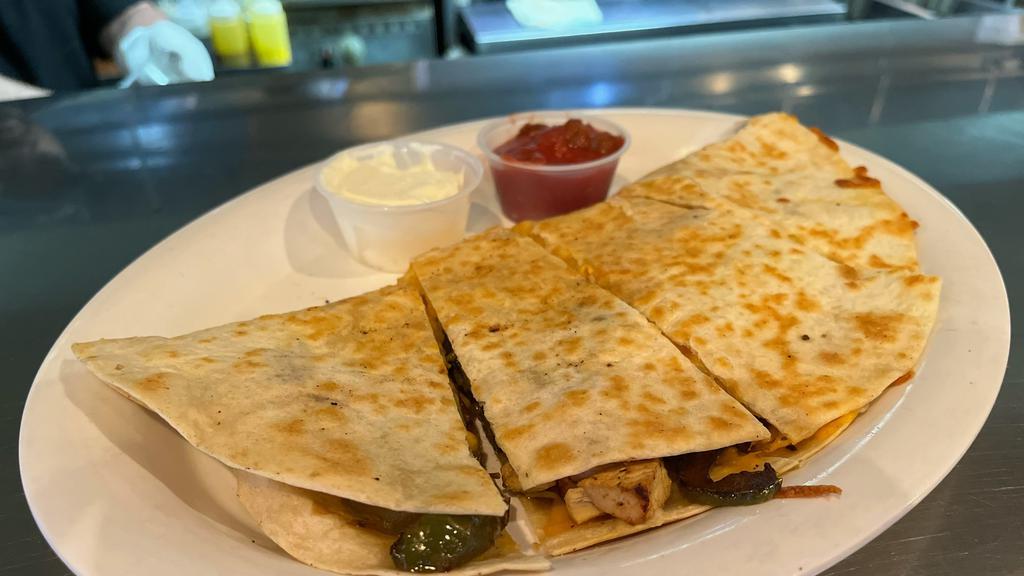 Chicken Quesadilla · A large flour tortilla filled with chicken, onions, peppers, and cheese.  Served with sour cream and ranch