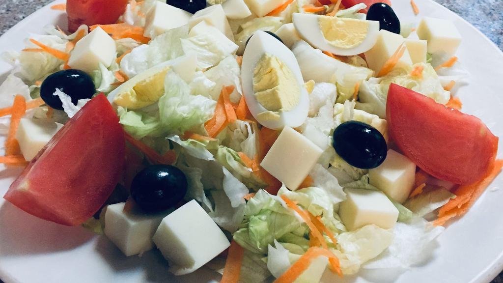 Salada Portuguesa With Chicken · Lettuce, tomato, onions, olives, carrots, cheese, and boiled egg.