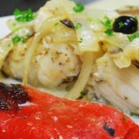 Bacalhau A Lagareiro · Grilled Codfish with olive oil, garlic served with onions, roasted red peppers and roasted p...