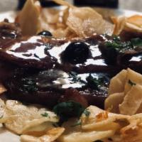Bife A Portuguesa · Ny sirloin with prosciutto in garlic wine sauce and potatoes chips