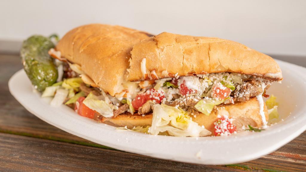 Torta · Mexican sandwich filled with refried beans, cheese, lettuce, sour cream and your choice of meat.