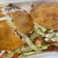 Gordita · Deep fried masa sliced and stuffed with your choice of meat, lettuce, cotija and sour cream.