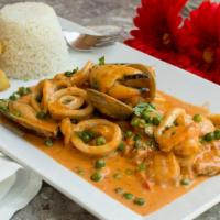Pescado A La Macho · Try this traditional Peruvian dish of fried fish fillet cover in a creamy seafood sauce made...