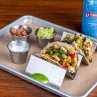 Fish Tacos · seasonal fish, black bean corn salsa, pico de gallo, guacamole, cilantro crema