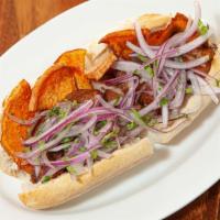 Pan Con Chicharron · A sandwich made with fried pork, sweet potatoes and salsa criolla.