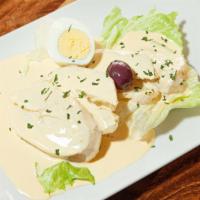 Papa A La Huancaina · Potatoes covered with spicy cream sauce made with Peruvian yellow pepper and white cheese.