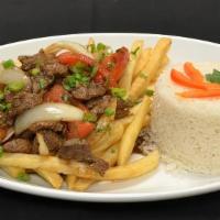 Lomo Saltado · Beef, chicken, or fish stir fried sauteed with tomatoes and onions flamed with wine and serv...
