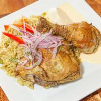Arroz Con Pollo · Leg and thigh chicken with green rice cooked with cilantro, served with papa a la huancaina ...