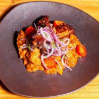 Carapulcra Con Costillar De Cerdo · Traditional sun dried potato stew with pork and chicken. Served with roasted pork ribs and s...