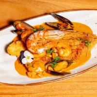 Pescado A Lo Macho · Deep fried fillet white fish topped with shrimp, calamari and mussels in aji panca creamy sa...