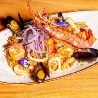 Arroz Con Mariscos · Peruvian style seafood paella, shrimp, mussels, and calamari and salsa criolla.