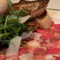 American Wagyu Carpaccio* · SRF Wagyu tenderloin, arugula, EVOO, parmesan, grilled ciabatta