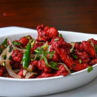 Chicken 65 (Dry) · Tender fried chicken tossed in spiced yogurt sauce with curry leaves.