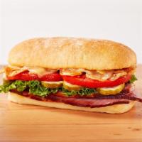 The Honeybaked · Honey Baked Ham topped with Swiss cheese, lettuce, tomato, pickles, crispy onions, Duke’s® D...