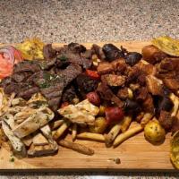 Picada Para 2 Personas · Pieces of steak, chicken, arepa, criolla potato, morcilla, chorizo, and plantain .