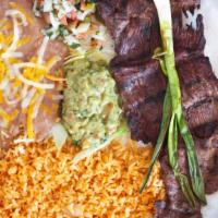 Carne Asada · Steak cooked with onions on top. Served with rice, beans, salad and tortillas.