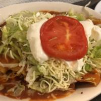 Enchilada Supreme · Four rolled corn tortillas, one beef, one chicken ,one cheese and one bean, topped with ench...