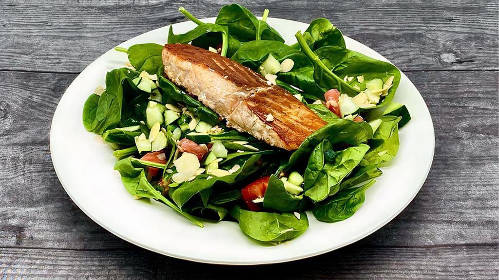 Spinach Salad With Grilled Salmon · Fresh Spinach, Diced Tomatoes, Cucumbers, and Sliced Almonds topped with a perfectly Grilled piece of Salmon, served with our New Dijon Mustard Vinaigrette dressing.