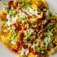 Chicken Nachos · Tortilla chips covered with grilled chicken, queso, corn, beans, lettuce, pico de Gallo, jal...