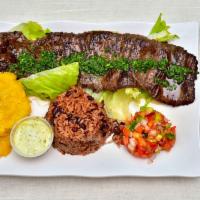 Churrasco Con Camarones · Skirt steak with grilled shrimp. Servidos con dos acompanantes у una tortilla: arroz, casami...