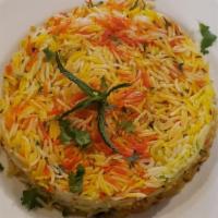 Lamb Biryani · Basmati rice with lamb and spices. Served with raita and curry sauce. Gluten-free. Nut-free.