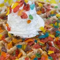 Tutti Frutti · Buttermilk waffle with “fruity pebbles” baked inside and topped with vanilla drizzle, fruity...