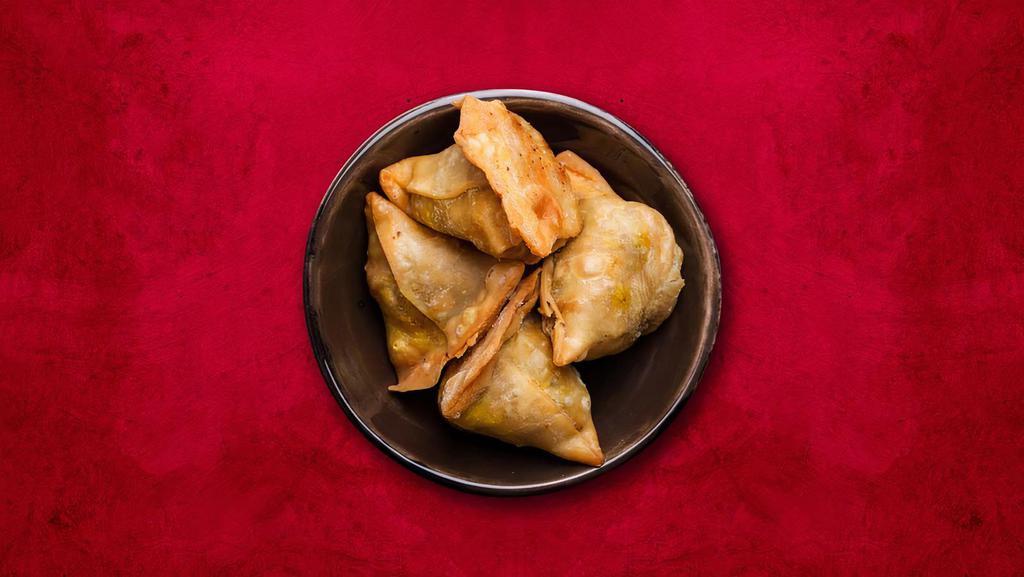 Solo Samosa · Triangular shaped flaky pastry filled with spicy potato usually served with a side of chutney.