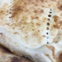 Naan · A semi-fluffy soft white flour bread baked in a clay oven fresh when you order.