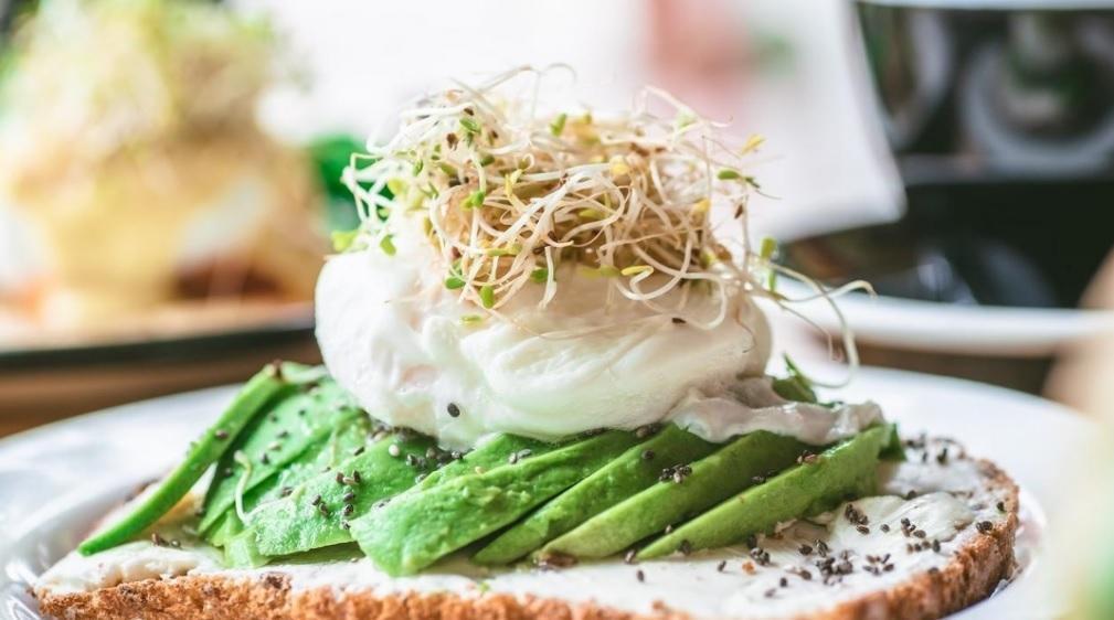 Avocado Toast · Multigrain Toast topped with Whipped Cream Cheese, Ripe Avocado, Extra Virgin Olive Oil, Seed Mix and Alfalfa Sprouts. Served with a side house salad & roasted vegetables.