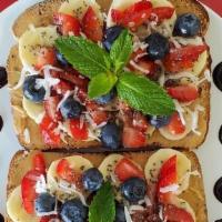 Berry Beneficial Toast · Toasted Multigrain slices topped with Creamy Peanut Butter, Banana Slices, Strawberries, Blu...