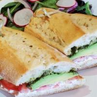 Avocado Flute · Our French Baguette topped with stracciatella, herby pesto, ripe avocado & roma tomatoes. Se...