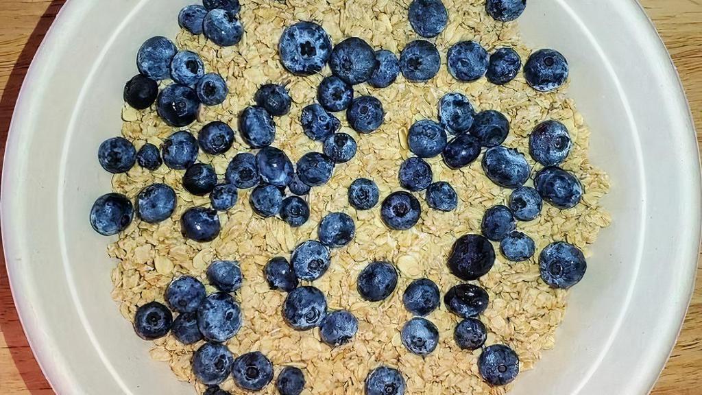 Peanut Bowl · Blended banana, peanut butter & almond milk topped with granola & blueberries.