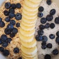 Maca Energy Bowl · Blended acai, banana & maca topped with oatmeal, banana, blueberries & coconut flakes.