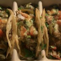 Shrimp Tacos · Sauteed shrimp.

Topped with your choice of shredded cheese, onions, cilantro, jalapenos, re...
