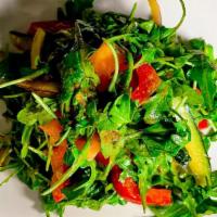 Ginger Arugula Salad · House made ginger dressing, arugula, peppers, onions, tomatoes, and garlic