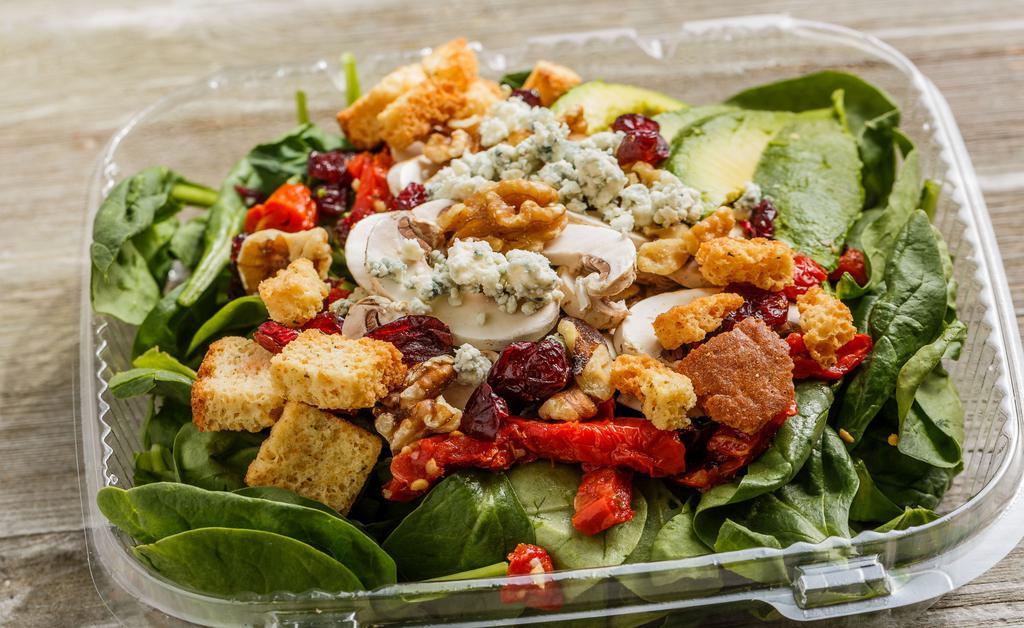 Walnut Spinach Salad · 420 cal. Baby spinach, walnut pieces, crumbled bleu cheese, avocado, sun-dried tomatoes, mushrooms, dried cranberries, croutons, side of balsamic vinaigrette.