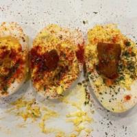 Deviled Eggs · Hot honey sauce, fried chicken skin, smoked paprika.
