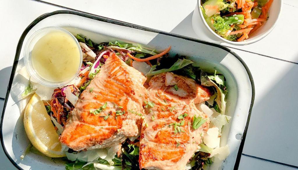 Keto Salmon Salad · Two, 4-oz. grilled salmon fillets served over a bed of leafy greens, kale, carrots, red cabbage, and shaved parm, with lemon vinaigrette dressing on the side. Served with a side of Sesame Broccoli Salad (60g protein, 83g fat, 18g carbs, 5g fiber, 6g sugar, 1060 calories).