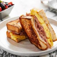 Americano Breakfast Sandwich* · Fluffy scrambled eggs, cheddar & provolone cheeses, ham griddled brioche & house potatoes
