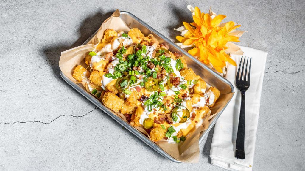 Loaded Cheese Fries Or Tots · Fresh fries or tots topped with a three-cheese queso  blend, bacon, scallions, and jalapeños.