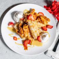 Chicken & Waffles · Waffles, sweet waffle sauce, honey siracha chicken poppers, strawberries, wiped cream, and p...