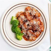 Sesame Chicken · Served with an egg roll chicken wing and white rice or fried rice.