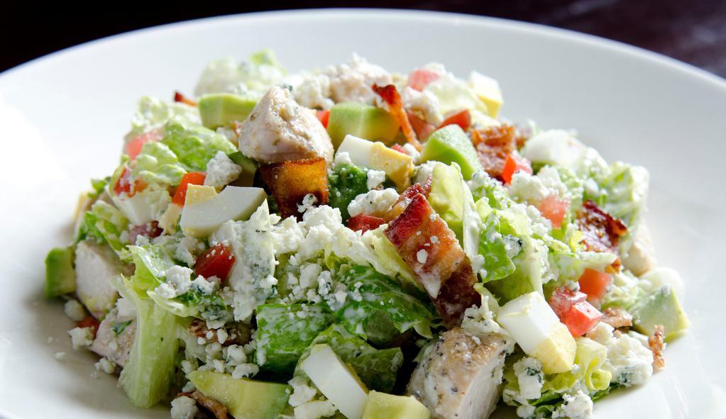 Cobb Salad · crisp romaine, roasted chicken breast, avocado, applewood-smoked bacon, crumbled blue cheese, diced Roma tomatoes, egg, tossed in Ranch OR Blue Cheese Dressing.