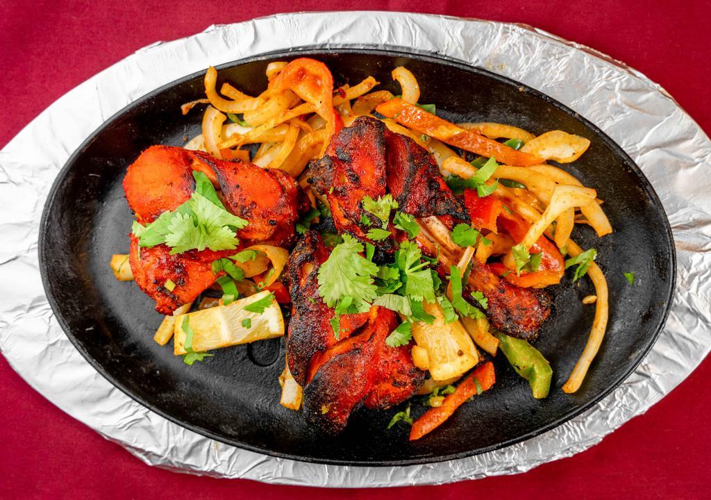 Tandoori Chicken (Half) · Sizzling half chicken, spiced in a combination of herbs, cooked to perfection in the tandoor.