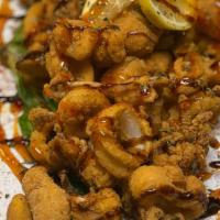 Fresh Calamari · Fried with fried jalapeño served on a bed of kale with sweet chili sauce and glazed with bal...