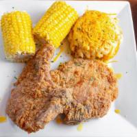 Pork Chops · Two center cut pork chops season and hand battered served with one side.
